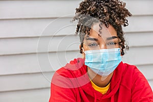 African American female young woman wearing face mask in Coronavirus COVID-19 pandemic