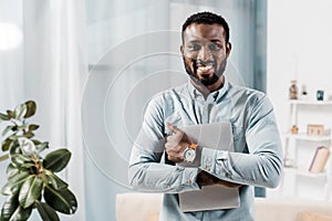 african american freelancer smiling with laptop photo