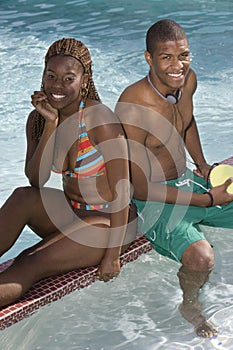 African American Friends Sitting Pool Side