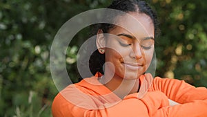 African American girl biracial teenager young woman outside smiling, laughing in a park or garden