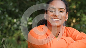 African American girl biracial teenager young woman outside smiling, laughing in a park or garden