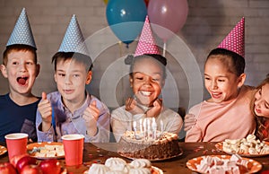 African-american girl celebrating birthday and making wish