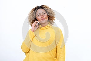 African american girl with curly hair talking on mobile and thinking phone by white background