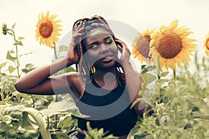 African American girl in a field of yellow flowers at sunset