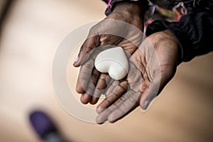 African-American girl hands holding a marble made heart