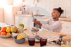 African-American girl having video chat with her mother