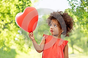 African american girl with heart shaped balloon