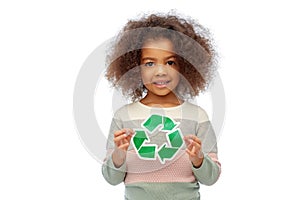 african american girl holding green recycling sign