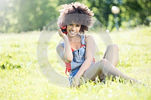 African american girl relaxing outdoor with headphones.