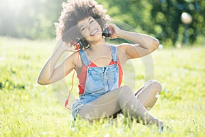 African american girl relaxing outdoor with headphones.