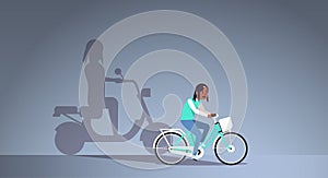 African american girl riding bike shadow of woman on motor scooter imagination aspiration concept female cartoon