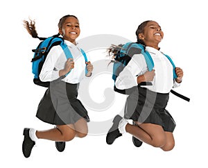 African American girl in school uniform jumping on background