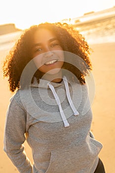 African American Girl Teenager Smiling on a Beach at Sunset