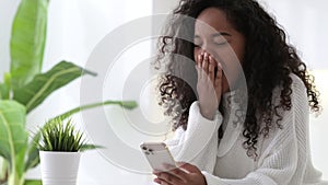African American Girl using iPhone 12 smartphone pressing finger, reading social media internet, typing text or shopping