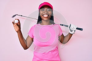 African american golfer woman with braids holding golf ball smiling with a happy and cool smile on face