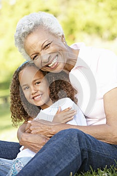 African American Grandmother And Granddaughter Relaxing In Park