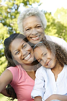 African American Grandmother, Mother And Daughter Relaxing In Pa