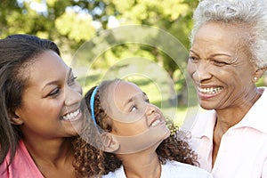 African American Grandmother, Mother And Daughter Relaxing In Pa