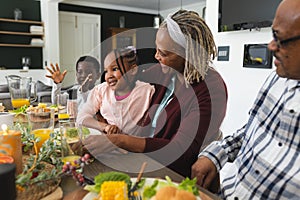 African american grandparents and grandchildren celebrating at thanksgiving dinner