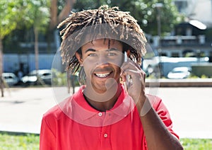 African american guy with amazing hairstyle at phone
