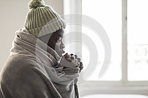 African american guy freezing in house in winter, copy space