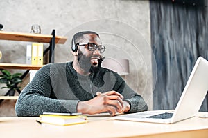 African-American guy with headset using laptop