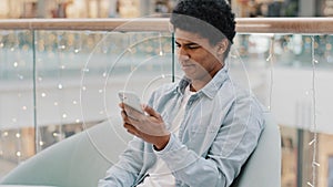 African american guy loser man playing mobile online betting game getting rejection message in phone loses reading bad