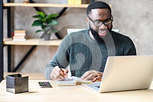 An African-American guy using laptop in the office