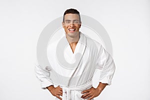 African American guy wearing a bathrobe with happy emotion. Isolated over whtie background.