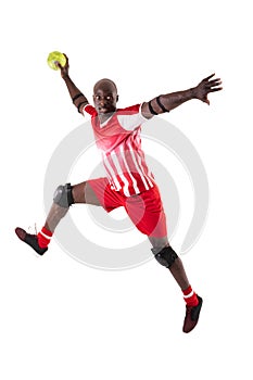 African american handball player jumping while throwing ball against white background