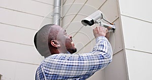 African American Handyman With CCTV Camera