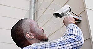 African American Handyman With CCTV Camera