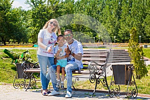 African American happy family: black father, mom and baby boy on nature. Use it for a child, parenting or love concept