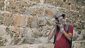 African american happy tourist taking photo on his dslr camera. Young man standing near famous building in Europe