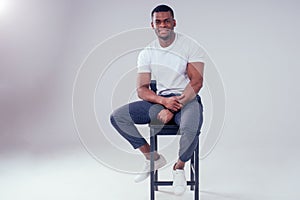 African American healthy male model in a cotton white t-shirt in studio