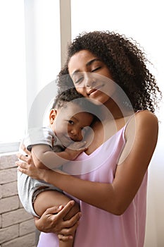 African-American  with her baby at home. Happiness of motherhood