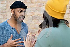 African american hipster man with piercing in discussion with girlfriend