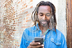 African american hipster young man using mobile smart phone