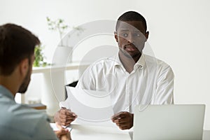 African-american hr manager looking doubtful skeptical about hir