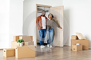 African American Husband And Wife Entering Embracing New Home