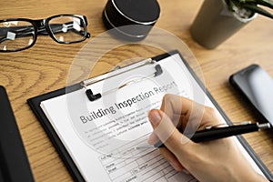 African American Inspector Checking Building Report