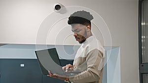 African american installer sets up security camera in office