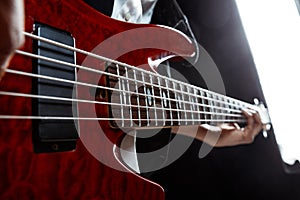 African American jazz musician playing bass guitar.