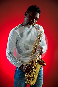 African American jazz musician playing the saxophone.