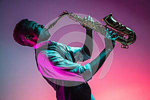 African American jazz musician playing the saxophone. photo