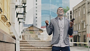 African american joyful businessman happy after talking phone about his new career