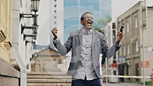 African american joyful businessman happy after talking phone about his new career