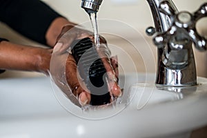 African American Lady washing her hands