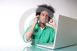African American listen to music with laptop