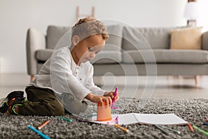 African American Little Boy Drawing Picture With Markers At Home